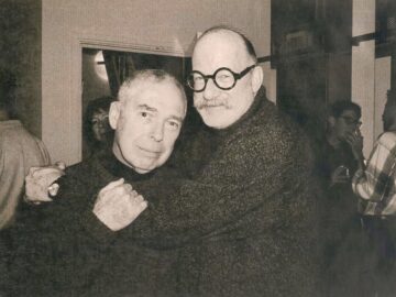 Friends hugging at gallery