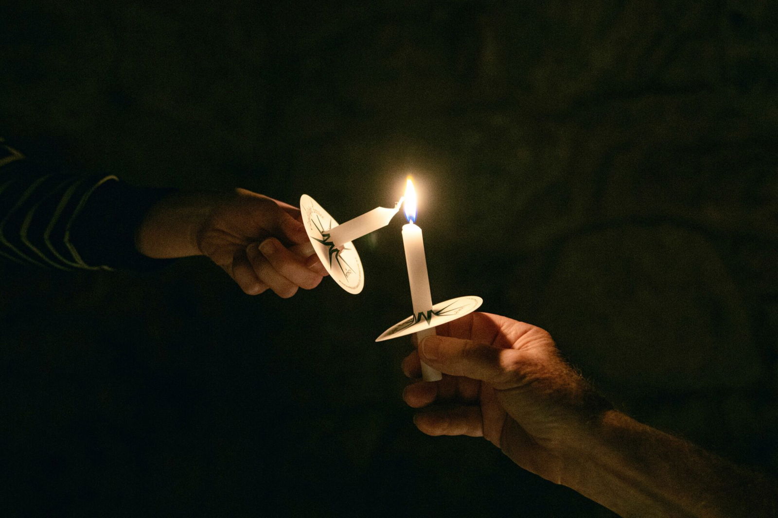 Lighitng candles together