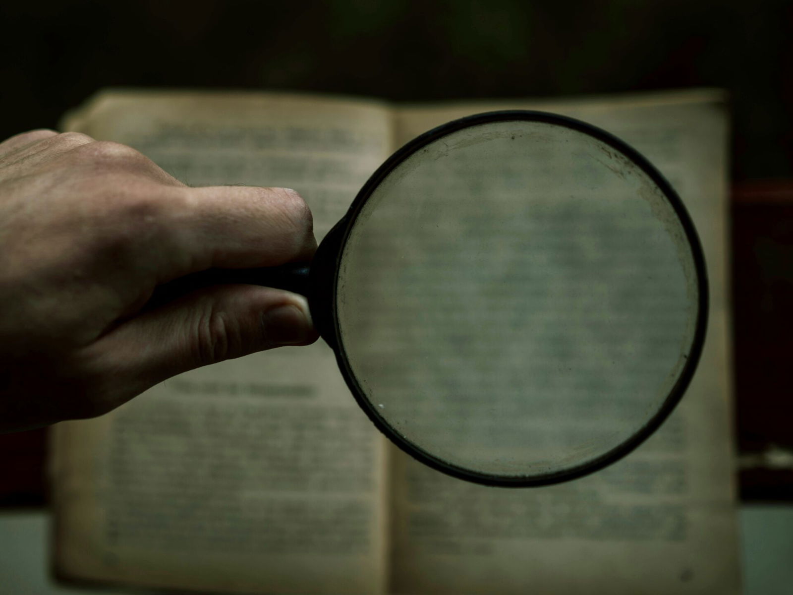 Person holding magnifying glass